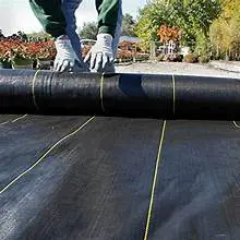 Landscape weed barrier fabric being rolled out for garden bed installation at JTR Garden Center in Youngstown Ohio